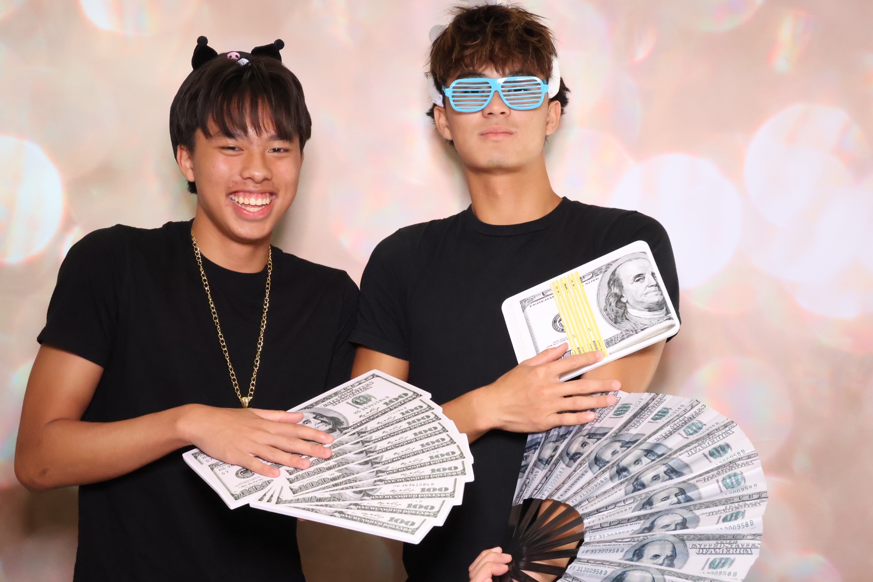 Two friends posing with oversized party props